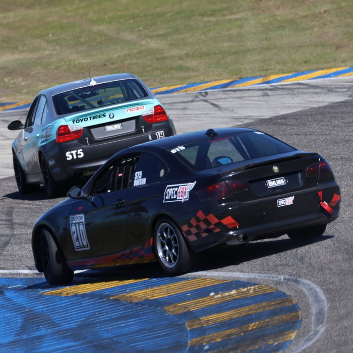 Black Condor race car on track.